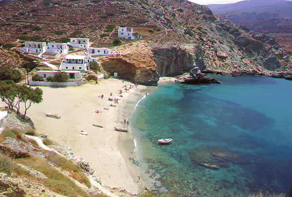 beach with buildings and crystal clear water