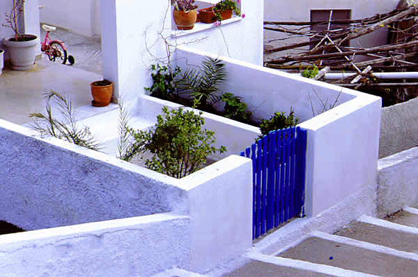 a blue gate and steps leading to it