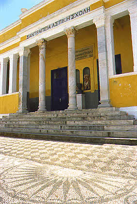 a neo classic structure with columns and mosiac courtyard