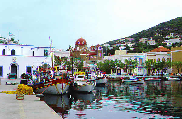 view of port with fishing boats and shops