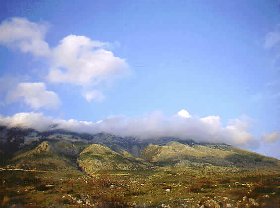 mountain with clouds creeping down slope